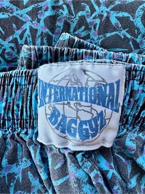 International Baggy Vintage Logo Shorts in Teal & Purple Print